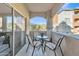 Cozy balcony with comfortable seating, table, and view of well-maintained grounds and buildings at 5401 E Van Buren St # 1068, Phoenix, AZ 85008