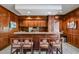 Elegant bar area featuring rich wood paneling, bar seating, and ample storage at 5401 E Van Buren St # 1068, Phoenix, AZ 85008