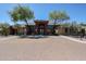 Clubhouse with beautiful trees, flowers, landscaping, and visible parking at 5401 E Van Buren St # 1068, Phoenix, AZ 85008