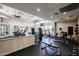 Bright fitness center with diverse exercise machines, fans, natural light, and rubber flooring at 5401 E Van Buren St # 1068, Phoenix, AZ 85008