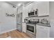 Contemporary kitchen featuring stainless steel appliances and bright white cabinets at 5401 E Van Buren St # 1068, Phoenix, AZ 85008