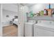 Bright laundry room with modern washer and dryer units plus convenient shelving for storage solutions at 5401 E Van Buren St # 1068, Phoenix, AZ 85008