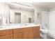 Bright bathroom featuring a large mirror, wooden cabinets, and a shower-tub combo at 5401 E Van Buren St # 2050, Phoenix, AZ 85008