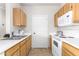 Efficient kitchen with white appliances, light wood cabinets, and a functional layout at 5401 E Van Buren St # 2050, Phoenix, AZ 85008