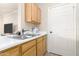 Well-lit kitchen with white countertops, wood cabinetry, and stainless steel double sink at 5401 E Van Buren St # 2050, Phoenix, AZ 85008