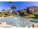 Serene community pond with a fountain and lush landscaping for a peaceful view at 5401 E Van Buren St # 2050, Phoenix, AZ 85008