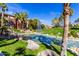 Beautiful community pond with fountain, palm trees, and lush landscaping, offering a serene atmosphere for relaxation at 5401 E Van Buren St # 2050, Phoenix, AZ 85008