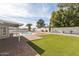 Serene backyard featuring a well-maintained lawn, a charming pool, and tasteful landscaping, creating a private retreat at 5412 E Tierra Buena Ln, Scottsdale, AZ 85254