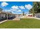 Sprawling backyard with green lawn, brick patio, desert landscaping, and a sparkling in-ground pool at 5412 E Tierra Buena Ln, Scottsdale, AZ 85254