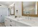 Bright bathroom featuring a double vanity with quartz countertops, framed mirrors, and walk-in shower at 5412 E Tierra Buena Ln, Scottsdale, AZ 85254