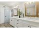 Bathroom with double vanity, white cabinets, quartz countertops, and stylish decor at 5412 E Tierra Buena Ln, Scottsdale, AZ 85254