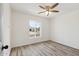 Bedroom featuring light-colored walls, a ceiling fan, and wood-look flooring at 5412 E Tierra Buena Ln, Scottsdale, AZ 85254