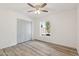 Well-lit bedroom with a large window, spacious closet, and wood-look floors at 5412 E Tierra Buena Ln, Scottsdale, AZ 85254