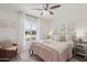 Inviting bedroom offering a fluffy blanket, soft pillows, side tables, and a window view at 5412 E Tierra Buena Ln, Scottsdale, AZ 85254