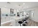 The modern eat-in kitchen features quartz counters, white cabinets and a view of the backyard pool at 5412 E Tierra Buena Ln, Scottsdale, AZ 85254