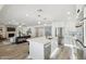 Bright kitchen with stainless steel appliances, white cabinets, and an island with counter seating at 5412 E Tierra Buena Ln, Scottsdale, AZ 85254