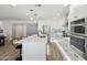 Bright, modern kitchen with stainless appliances, white cabinets, and quartz countertop island at 5412 E Tierra Buena Ln, Scottsdale, AZ 85254