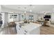 Bright kitchen featuring a center island, bar seating, and an adjacent dining area with backyard views at 5412 E Tierra Buena Ln, Scottsdale, AZ 85254