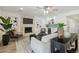 Spacious living room with stone fireplace, wet bar, wood-look floors, and modern decor at 5412 E Tierra Buena Ln, Scottsdale, AZ 85254