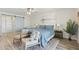 Comfortable main bedroom with hardwood floors, ceiling fan, barn door closet, and accent seating at 5412 E Tierra Buena Ln, Scottsdale, AZ 85254