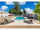 Private pool with a rock surround, mature shade trees, and relaxing lounge seating at 5412 E Tierra Buena Ln, Scottsdale, AZ 85254
