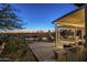 Inviting backyard patio with desert landscaping, shaded lounge area, and water feature for tranquil outdoor living at 5742 S Creosote Dr, Gold Canyon, AZ 85118