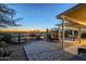 Inviting backyard patio with desert landscaping, shaded lounge area, and water feature for tranquil outdoor living at 5742 S Creosote Dr, Gold Canyon, AZ 85118