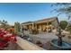 Beautiful backyard with covered patio, comfortable seating, fountain, and mature desert landscaping at 5742 S Creosote Dr, Gold Canyon, AZ 85118