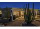 Desert backyard featuring cacti, a covered patio, and views of the desert landscape at 5742 S Creosote Dr, Gold Canyon, AZ 85118