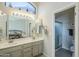 Clean bathroom with double sinks, light colored cabinetry, and a view to the bedroom at 5742 S Creosote Dr, Gold Canyon, AZ 85118