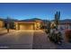 Beautiful home exterior featuring desert landscaping and a spacious garage at dusk at 5742 S Creosote Dr, Gold Canyon, AZ 85118