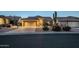 Attractive home exterior with a well-maintained lawn, desert landscaping, and a spacious two-car garage at 5742 S Creosote Dr, Gold Canyon, AZ 85118