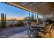 The patio is set up for entertaining with a sunset view on the golf course at 5742 S Creosote Dr, Gold Canyon, AZ 85118