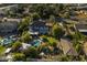 An aerial view of a spacious backyard featuring a pool, patio, and play area, surrounded by mature trees at 616 E Carver Rd, Tempe, AZ 85284