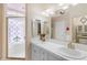 Bright bathroom with a dual sink vanity and a well-lit mirror at 616 E Carver Rd, Tempe, AZ 85284