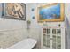 Bathroom featuring freestanding tub, marble tiling, and a decorative mermaid mosaic at 616 E Carver Rd, Tempe, AZ 85284