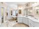 Elegant bathroom with dual vanities, a standalone tub, and decorative chandelier at 616 E Carver Rd, Tempe, AZ 85284