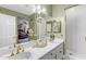 Bathroom featuring double sinks, gold-colored faucets, and a shower stall at 616 E Carver Rd, Tempe, AZ 85284