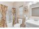 Modern bathroom featuring a tile surround bathtub, stylish fixtures, and an art piece above the toilet at 616 E Carver Rd, Tempe, AZ 85284