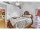 Bedroom with detailed wood bedframe, ceiling fan, and closet at 616 E Carver Rd, Tempe, AZ 85284