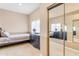 Bedroom featuring decorative sliding mirrored closet and light-colored flooring at 616 E Carver Rd, Tempe, AZ 85284