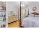 Bedroom with striped wallpaper, a four-poster bed, and a vanity at 616 E Carver Rd, Tempe, AZ 85284