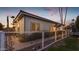 Inviting single story home featuring a fenced yard and desert landscaping at sunset at 616 E Carver Rd, Tempe, AZ 85284