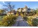 Attractive two-story home with a well-manicured front yard and a charming walkway lined with flowering bushes at 616 E Carver Rd, Tempe, AZ 85284