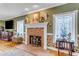 Living room featuring a brick fireplace, classic decor, and natural light from windows at 616 E Carver Rd, Tempe, AZ 85284