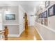 Upstairs hallway with hardwood floors and gallery wall at 616 E Carver Rd, Tempe, AZ 85284