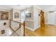 Hallway with hardwood floors, staircase, and art at 616 E Carver Rd, Tempe, AZ 85284