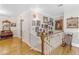 Hallway with beautiful hardwood floors and wooden staircase, plus art-covered walls and ornate decor at 616 E Carver Rd, Tempe, AZ 85284