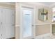 Hallway featuring a laundry room door and decorative mirror accent at 616 E Carver Rd, Tempe, AZ 85284