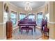 Stylish room with a grand piano, chandelier, and large windows offering pleasant views at 616 E Carver Rd, Tempe, AZ 85284